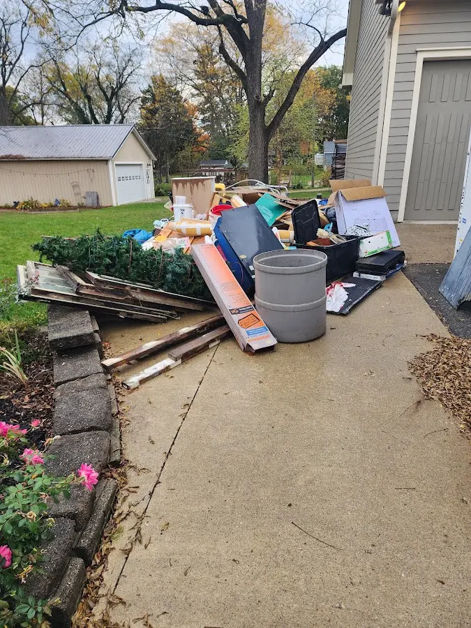 Dumpster being loaded with debris for Residential Dumpster Rental in Trenton